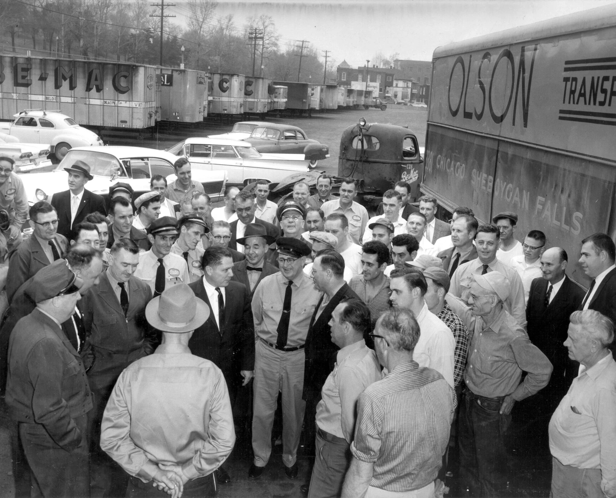 workers gathering around to hear speech